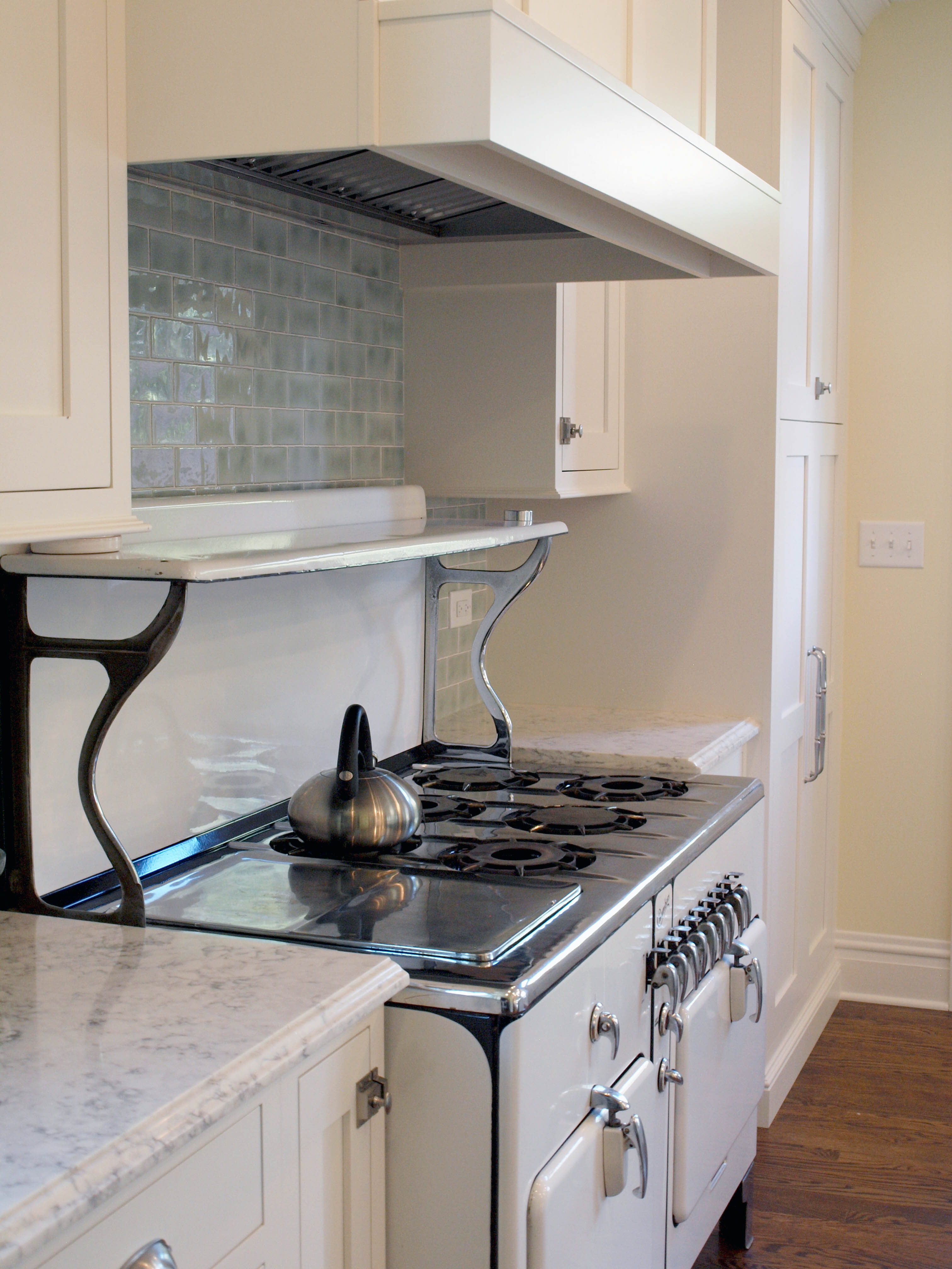 old style stove with shelf above burners